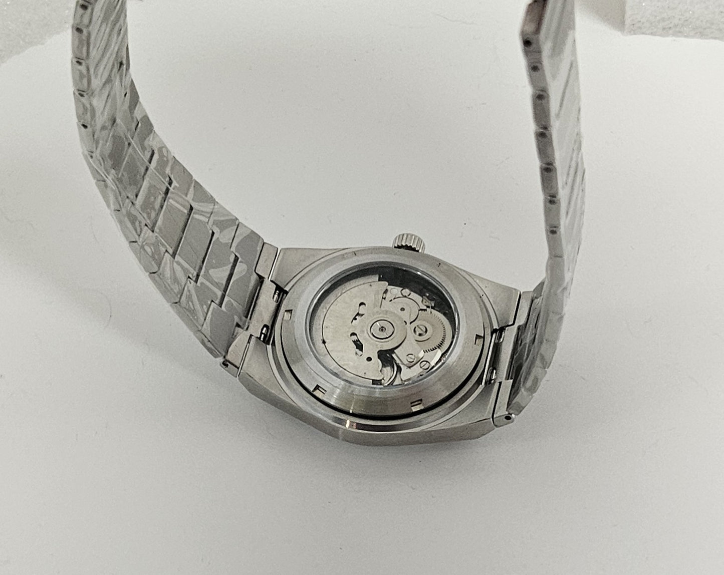 Watch back cover with metal band on white background