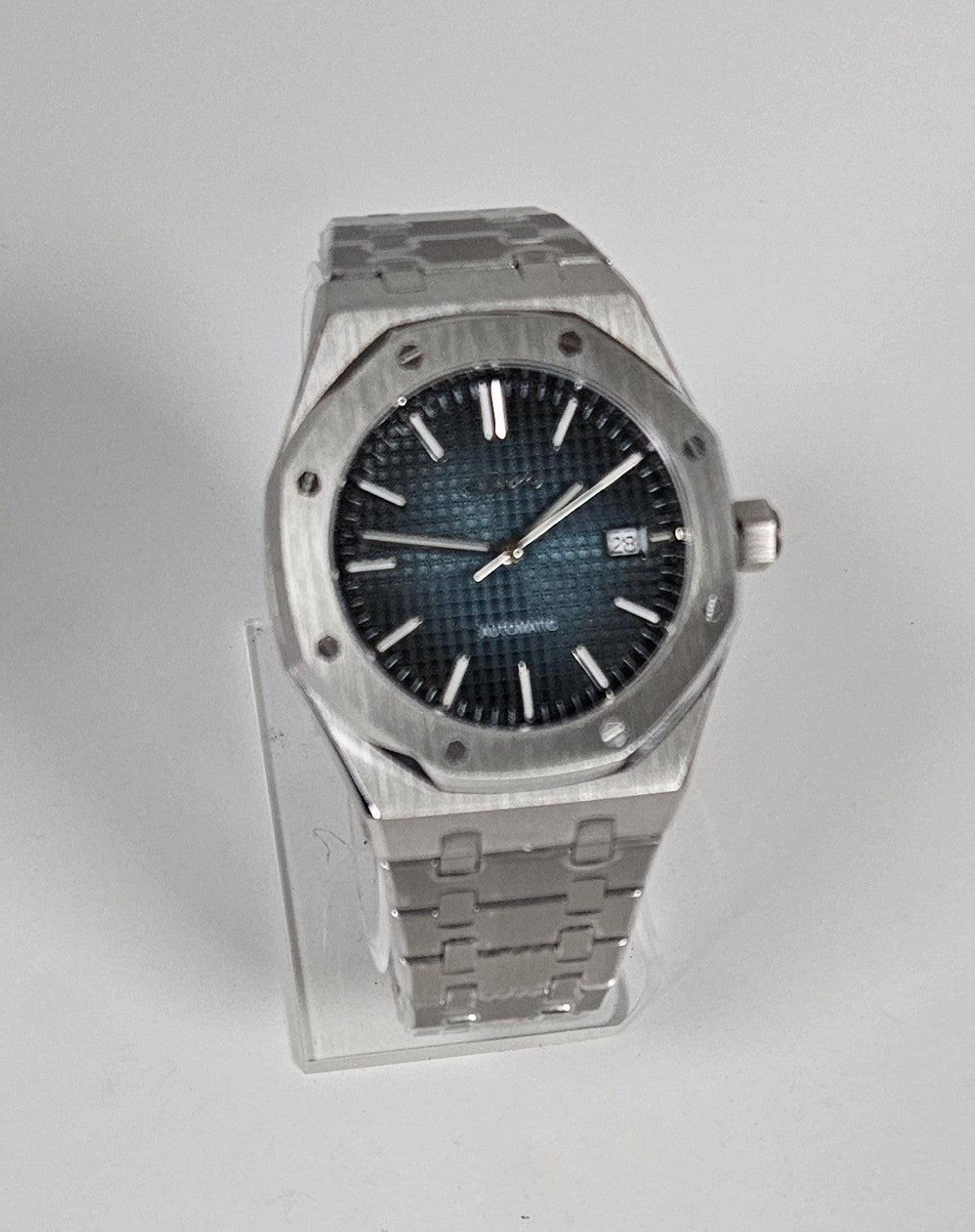 Wristwatch with metallic case and blue face on white background