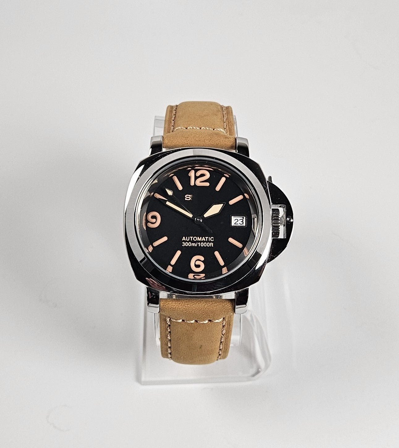 Watch with brown leather strap on a white background