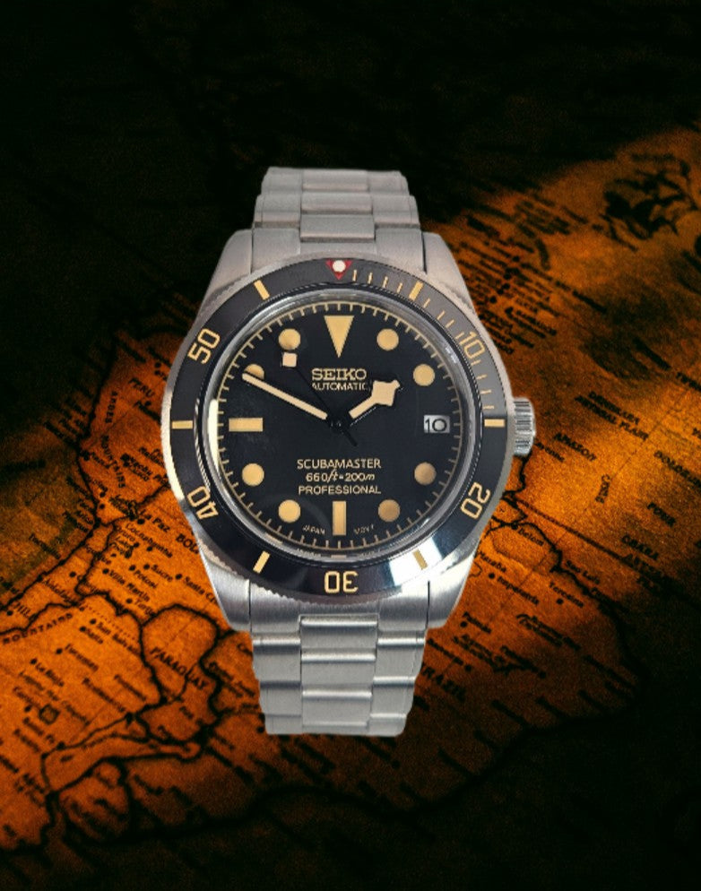 Seiko watch with black dial and silver metal strap on a world map background