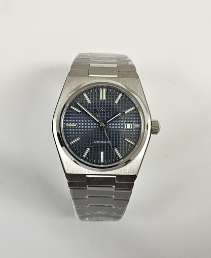 Silver wristwatch with dark face on white background