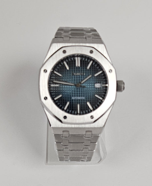A black and blue dial Seiko mod watch with a stainless steel bracelet and case.