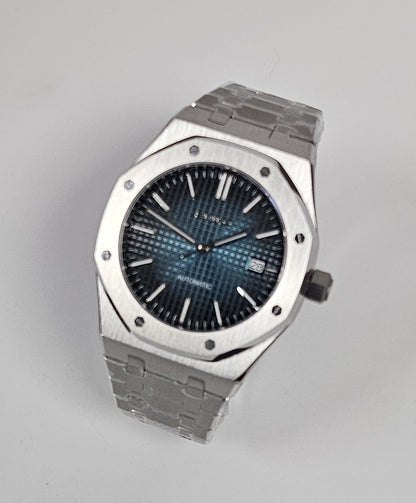 Luxury watch with blue face and silver case on white background