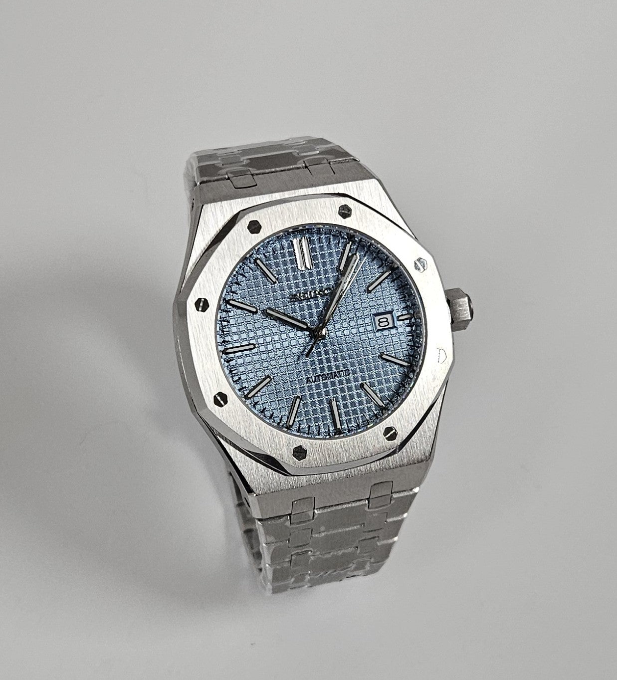A silver-toned Royal Oak Seiko Mod watch with a sky blue dial and a stainless steel bracelet.