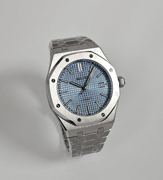 A silver-toned Royal Oak Seiko Mod watch with a sky blue dial and a stainless steel bracelet.