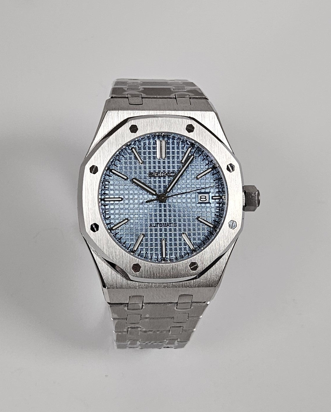 A silver-toned Royal Oak Seiko Mod watch with a sky blue dial and a stainless steel bracelet.