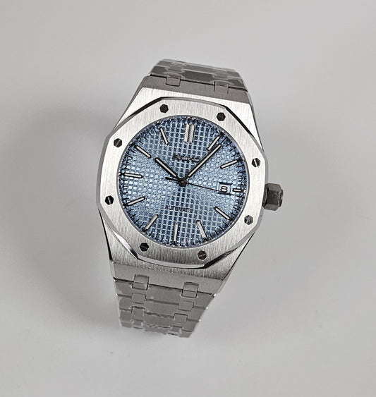 A silver-toned Royal Oak Seiko Mod watch with a sky blue dial and a stainless steel bracelet.