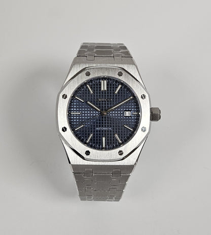 A black dial Royal Oak Seiko Mod watch with a stainless steel bracelet and a screw down case back.