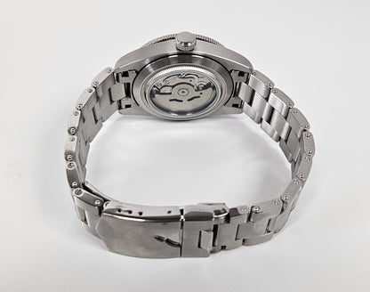 Silver watch with a metallic band on a white background