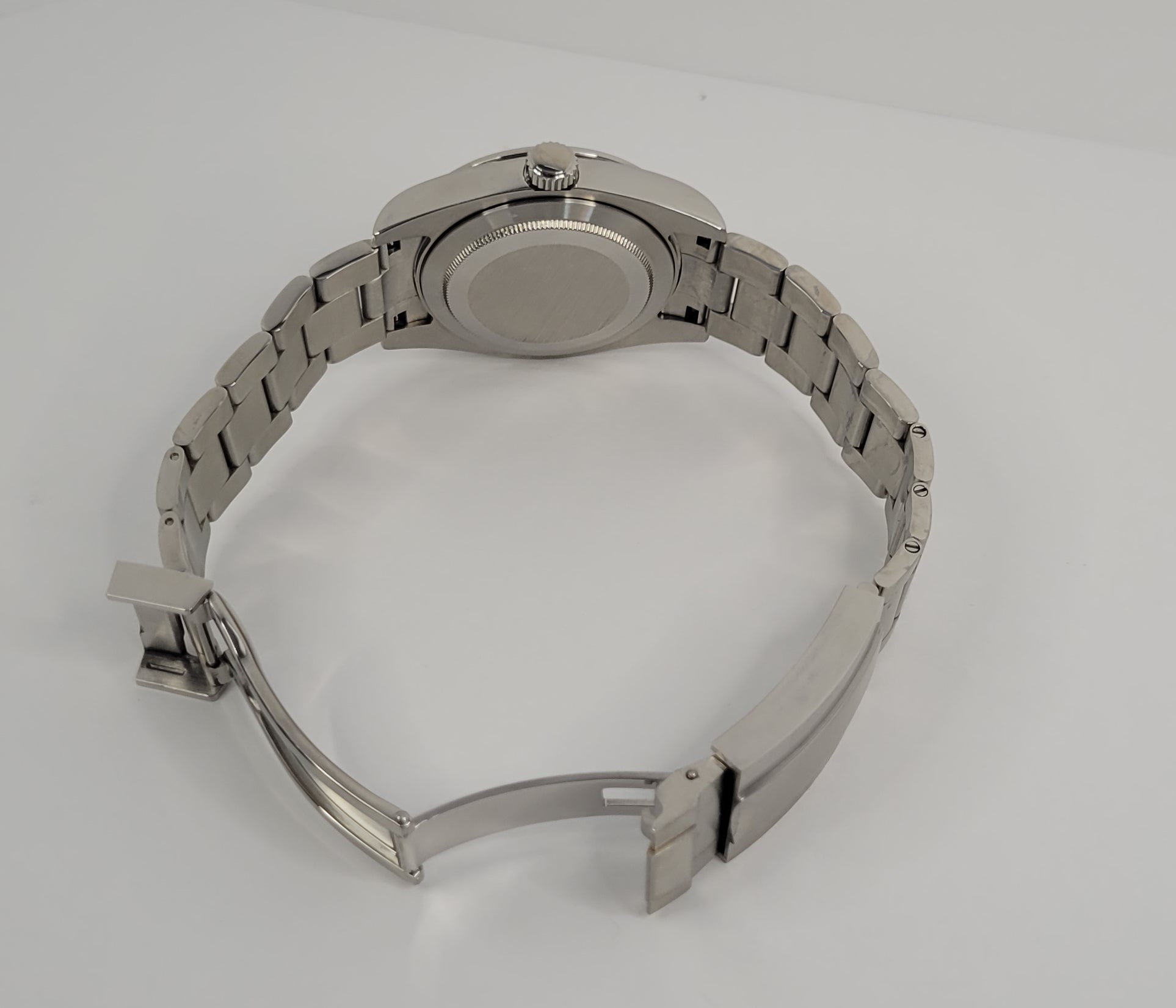 Silver watch with metal band on a white background