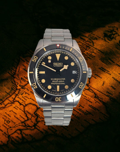 Seiko watch with black dial and silver metal strap on a world map background