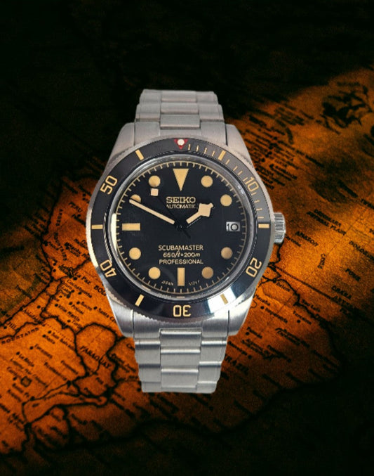 Seiko watch with black dial and silver metal strap on a world map background