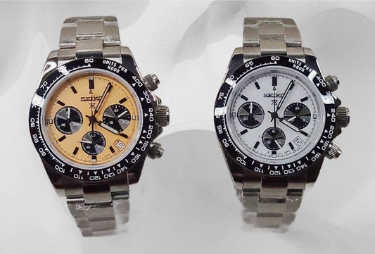 Two watches with different face designs on a white background